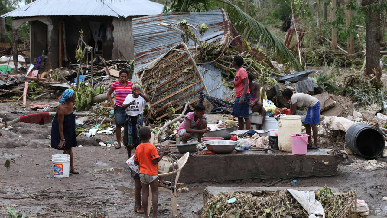 los-efectos-devastadores-del-huracan-matthew-en-haiti-06-10-2016-una-familia-se-reune-en-medio-de-los-escombros-en-les-cayes-haiti-efe